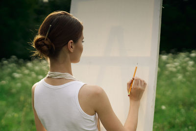 Portrait of young woman looking at camera