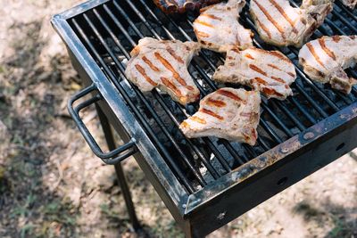 High angle view of pork meat on barbecue grill