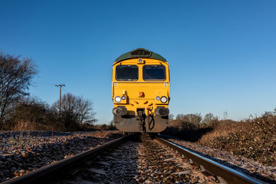 Low angle point of view of a freight locomotive approaching on a railway in an industrial safety