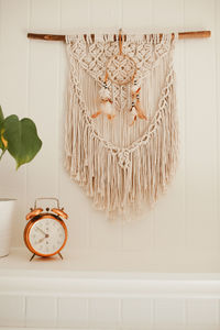 Wall macrame with house plants and vintage alarm clock