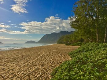 Scenic view of sea and mountains against sky