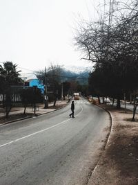 Man on snow covered road