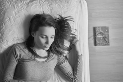 Directly above shot of young woman sleeping on bed at home