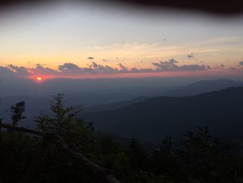 Scenic view of silhouette mountains against sky at sunset