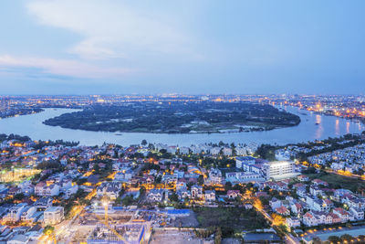 High angle view of illuminated cityscape against sky