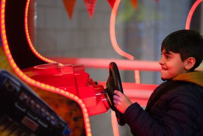 Portrait of child playing arcade video game