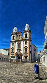 Low angle view of old building against blue sky