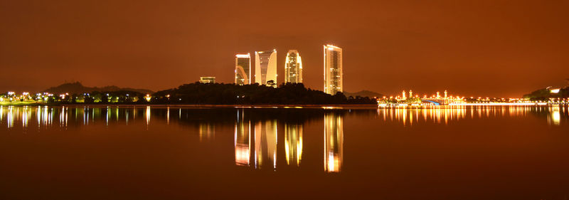 Reflection of illuminated buildings in water at night