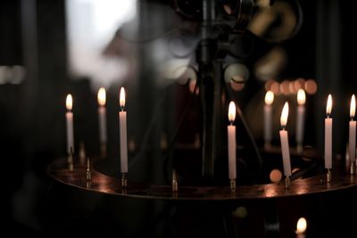Close-up of burning candles in temple