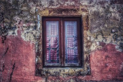 Low angle view of window on old building