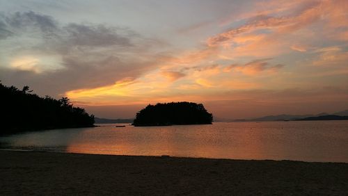 Scenic view of sea against orange sky