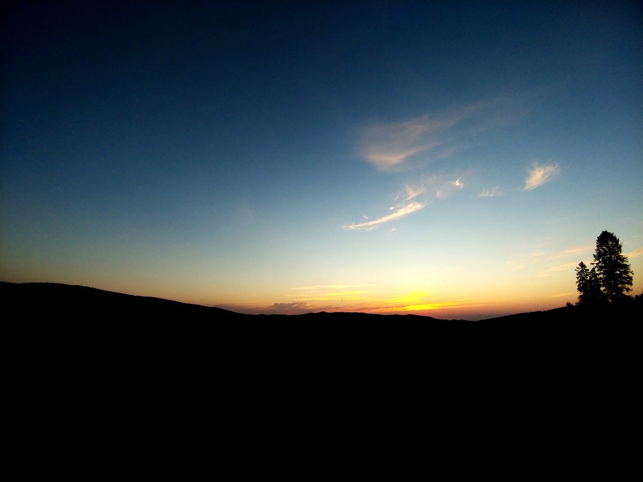 sky, silhouette, sunset, beauty in nature, tranquil scene, copy space, tranquility, nature, environment, scenics - nature, landscape, no people, outdoors, orange color, cloud - sky, tree, mountain, idyllic, plant, land