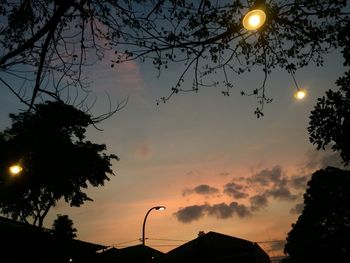 Low angle view of silhouette street light against sky at sunset