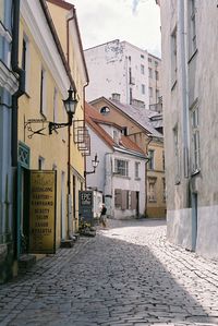 Road amidst buildings against sky