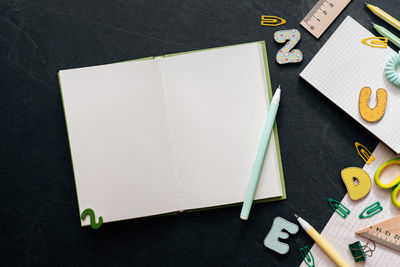 High angle view of pen and book on table