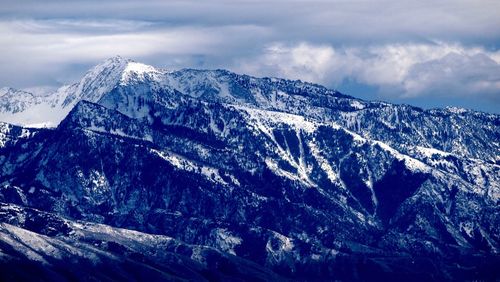 Scenic view of wasatch mountains against cloudy sky