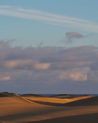 Scenic view of desert against sky during sunset