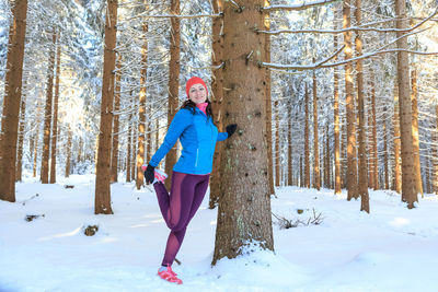 Full length of woman standing on snow covered land