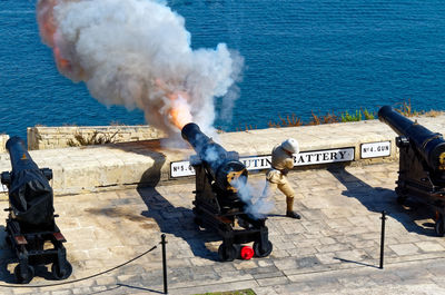 High angle view of military officer escaping from fire at saluting battery