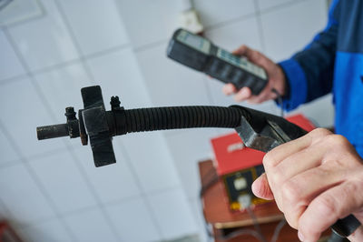 Close-up of man examining hand tool