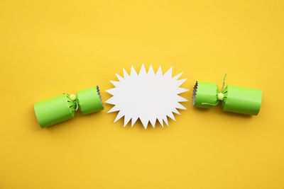 High angle view of light bulb on yellow background