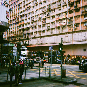 People on city street by buildings