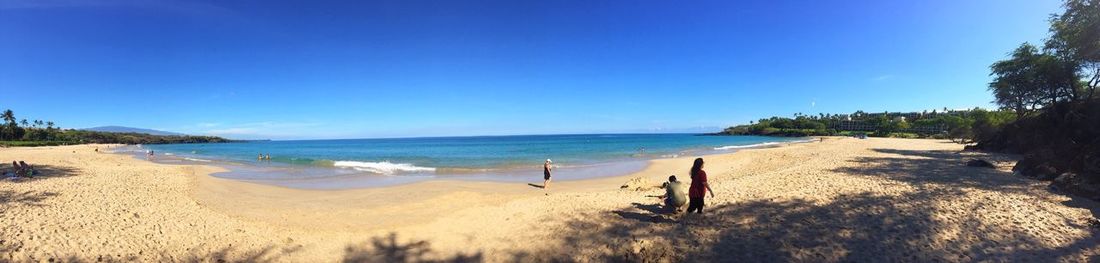 Scenic view of beach against blue sky