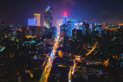 High angle view of city lit up at night