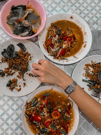 High angle view of woman holding bowl of food