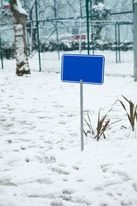 Snow covered land and trees on field