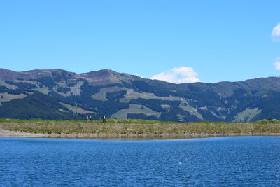 Scenic view of mountains against blue sky