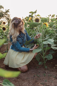 Young woman with flowers on field