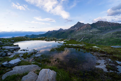 Scenic view of lake and mountains against sky