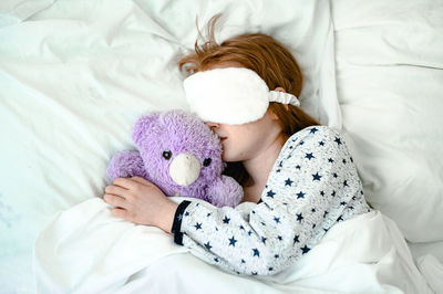 High angle view of woman sleeping on bed at home