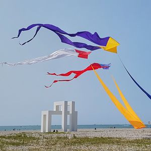 Low angle view of flags against clear sky