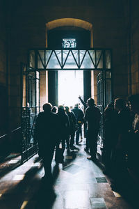 Rear view of people walking in building