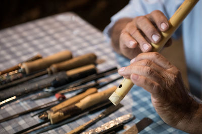 Cropped hands holding flute