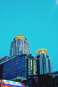 Low angle view of modern building against blue sky