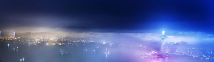 Illuminated cityscape against clear sky at night