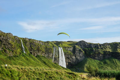 Scenic view of waterfall against sky