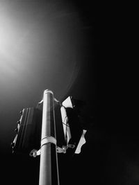 Low angle view of man working against sky at night