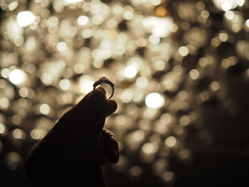 Close-up of hand holding illuminated lighting equipment