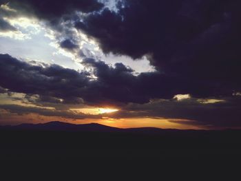 Scenic view of mountains against cloudy sky