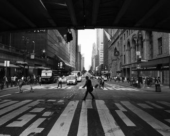 People walking on road along buildings