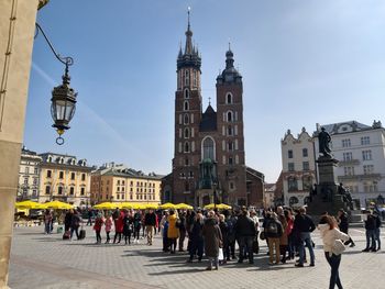 Group of people in front of buildings in city