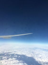 Airplane wing against blue sky