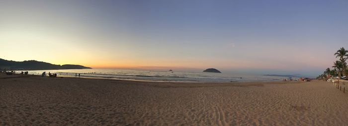 Scenic view of beach against sky during sunset