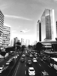 Traffic on city street against sky