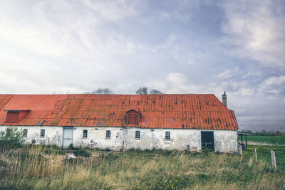 Houses on field against sky