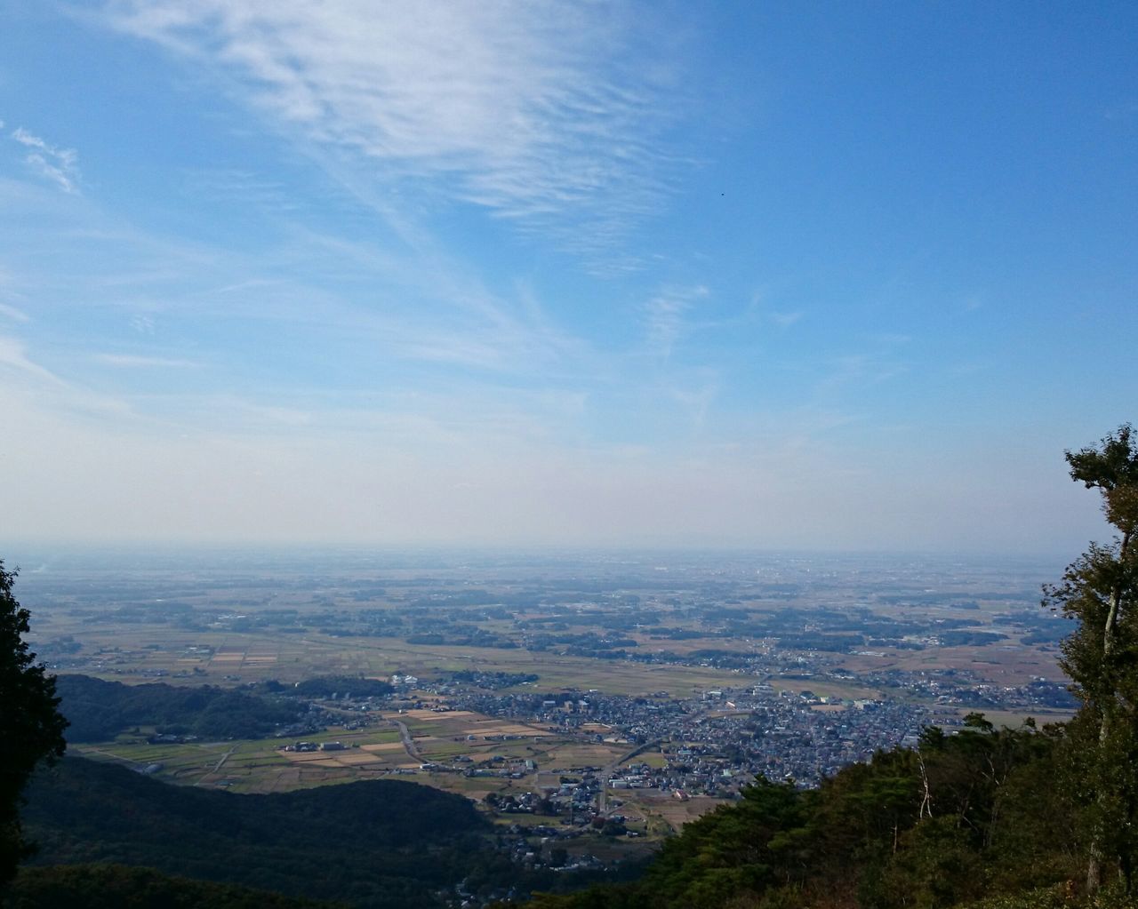 cityscape, high angle view, sky, scenics, building exterior, city, landscape, blue, built structure, crowded, tree, architecture, beauty in nature, mountain, tranquil scene, aerial view, sea, tranquility, nature, water